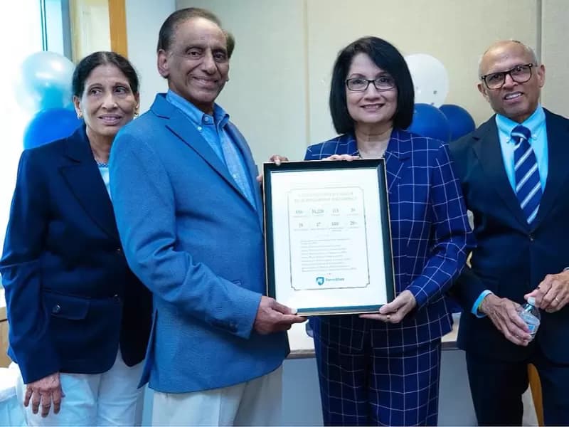 Sridhar Komarneni, distinguished professor of clay mineralogy, accepts a memento from Penn State President Neeli Bendapudi in recognition of his 50 years service in the College of Agricultural Sciences.