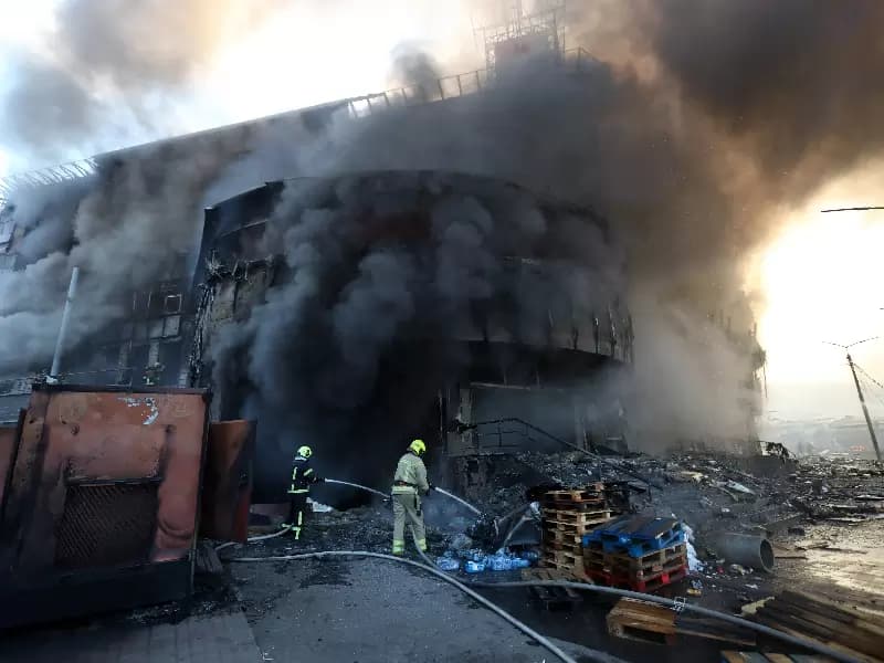 Kyiv: A firefighter attempts to put out a fire at a shopping center in Kiev, Ukraine, May 24, 2026. A massive ballistic missile attack struck the Ukrainian capital early Sunday, said Tymur Tkachenko, head of the Kiev City Military Administration.