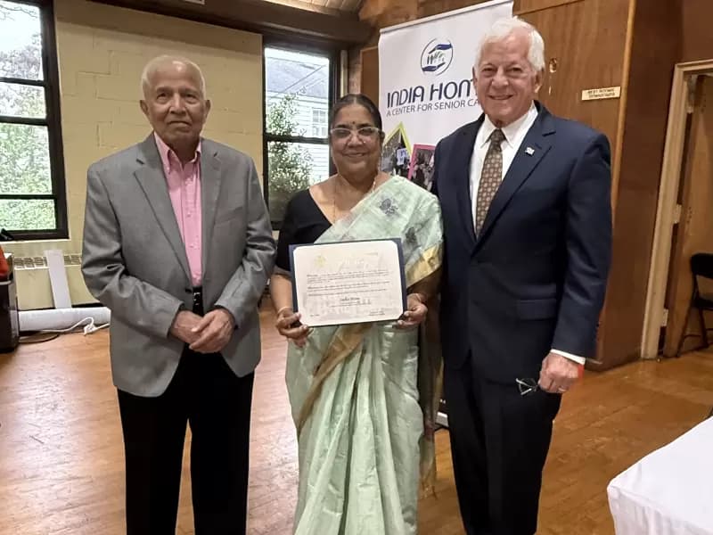 Assemblymember Charles Lavine presents a citation during the opening of India Home's new senior center in Hicksville, New York.