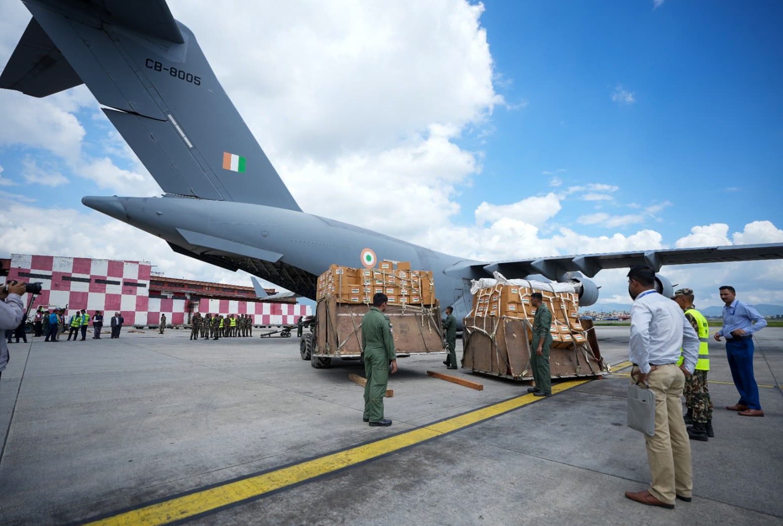 Security personnel unload humanitarian assistance and disaster relief (HADR) material, medicines and food packets sent by India from an Indian Air Force C-17 Globemaster aircraft to support relief and rescue efforts in flash flood-hit Nepal, in Kathmandu, on Thursday, August 27, 2026.